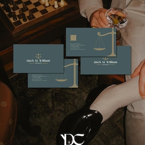May include: Business cards with a teal background and gold scale of justice graphic. The cards display the name "Mark M. William - lawyer" in white text. A chess board with pieces is visible in the background.