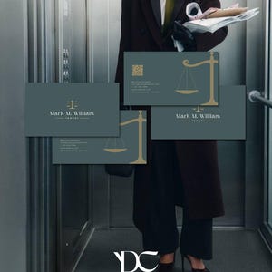 May include: Business cards with a teal background and gold scale of justice graphic. The cards feature the name "Mark M. William - lawyer" in white text. The image shows a person in a suit holding the cards.