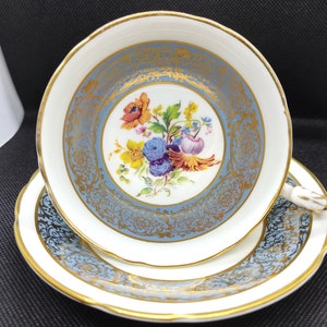 Vintage Paragon floral pattern in the center, grey and white with gold teacup and saucer.
