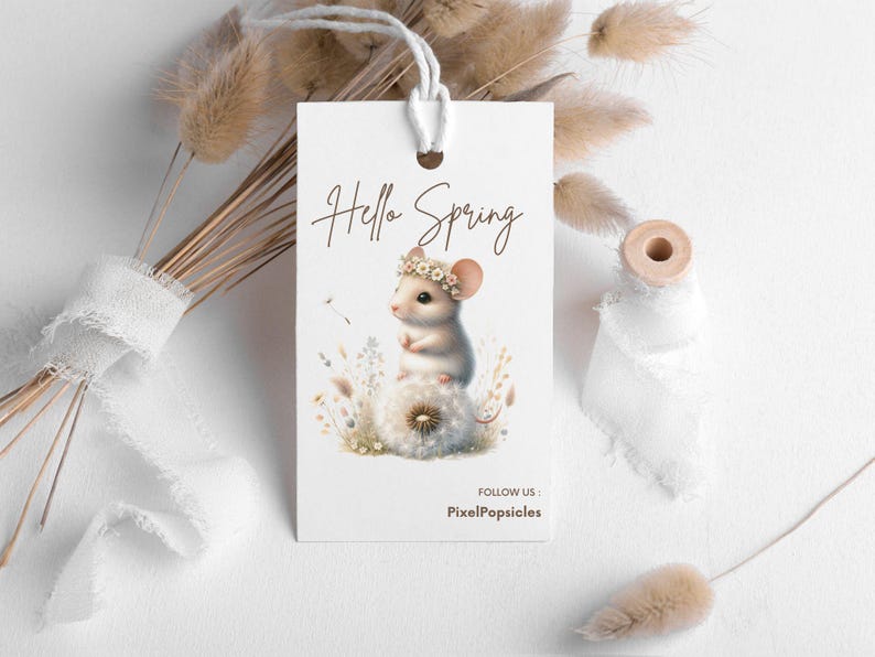 May include: A white tag with the text "Hello Spring" in brown lettering. A cartoon mouse with a flower crown sits on a dandelion. The text "Follow Us: PixelPopsicles" is at the bottom of the tag.