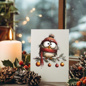 May include: A greeting card featuring a whimsical owl illustration. The owl is wearing a red hat and scarf, perched on a branch with ornaments. The card is set against a festive backdrop with a lit candle, pinecones, and greenery.