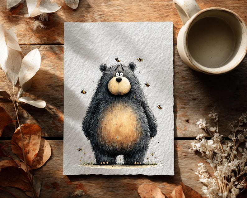 May include: A charming illustration of a bear looking concerned, with bees buzzing around it. The bear is depicted with black fur, a tan belly, and a light brown snout. The artwork is on textured paper, with a wooden background and a coffee mug.