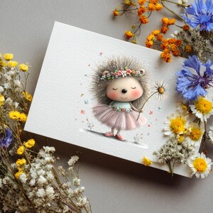 May include: A whimsical illustration of a hedgehog wearing a flower crown and a pink tutu, holding a daisy. The artwork is on a white card, surrounded by colorful dried flowers against a gray background. The hedgehog has a sweet, gentle expression.