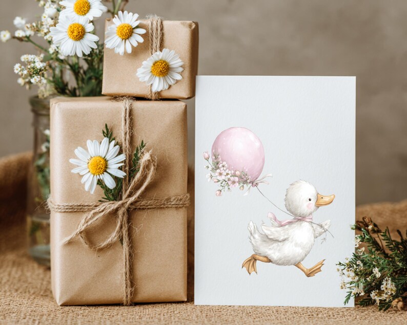 May include: A watercolour illustration of a white duckling running with a pink balloon. The image is on a white card next to wrapped brown paper gifts decorated with daisies. A vase of flowers is in the background.