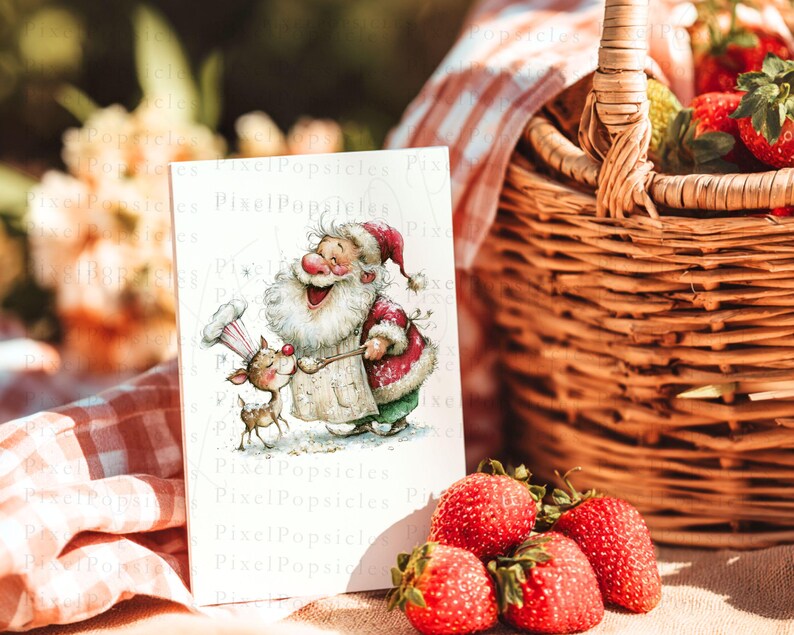 K&ouml;nnte beinhalten: Eine Gru&szlig;karte mit einer Aquarellillustration von Santa Claus und einem Rentier. Santa tr&auml;gt einen rot-wei&szlig;en Anzug und eine Kochm&uuml;tze. Die Karte befindet sich in der N&auml;he eines Picknickkorbs mit Erdbeeren. Der Text "Pixel Popsicles" ist sichtbar.