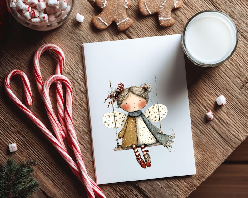 May include: A greeting card featuring a whimsical illustration of a fairy on a swing, with star-shaped wings and a patterned dress. The card is surrounded by candy canes, gingerbread cookies, marshmallows, and a glass of milk, creating a festive holiday scene.