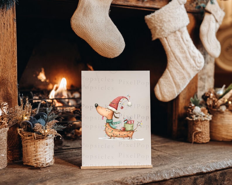 May include: A rectangular print featuring a whimsical illustration of a tan dachshund wearing a red Santa hat and a green scarf. The dog is wrapped in string lights and carries a green gift box on its back. The background is a plain light cream color.