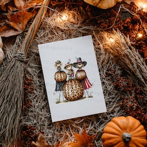 May include: A rectangular white greeting card featuring a whimsical illustration of three scarecrow-like figures standing on and beside large pumpkins with a leopard print pattern. The figures wear hats and colourful clothing, set against a plain background.