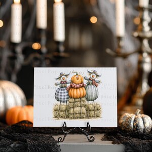 May include: A rectangular print featuring an illustration of two scarecrows and a central orange pumpkin with a face, all standing on hay bales. The scarecrows wear hats and scarves, with one in a blue plaid outfit and one in a green striped outfit.