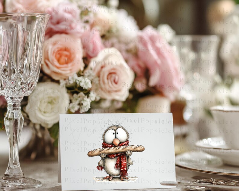 May include: A greeting card featuring a whimsical owl illustration. The owl, with large eyes and a red scarf, is holding a baguette. The background includes a floral arrangement and a crystal wine glass.