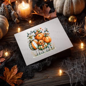 May include: A rectangular greeting card featuring a whimsical illustration of a group of smiling, anthropomorphic pumpkins wearing hats and scarves, with a small orange pumpkin character nestled in the centre, all set against a plain white background.