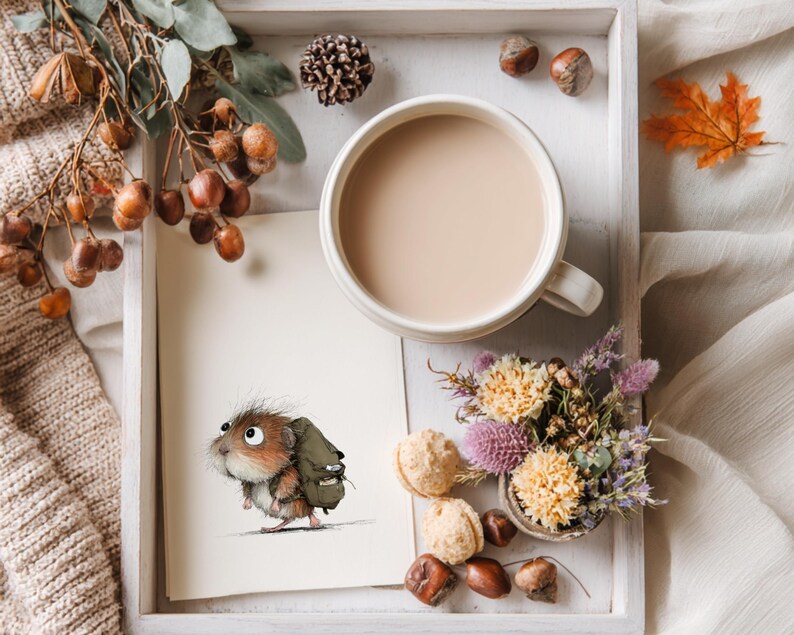 May include: A cozy autumn-themed still life. A mug of coffee sits beside a drawing of a small animal with a backpack. The scene includes fall foliage, nuts, and a small bouquet of flowers, all arranged on a white tray.