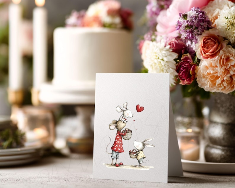 May include: A greeting card featuring an illustration of two mice holding baskets, with a red heart above them. The mouse on the left wears a red dress with white polka dots. A white cake and flowers are in the background.