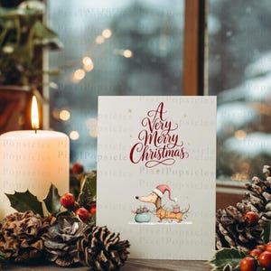 May include: A rectangular greeting card featuring the red text A Very Merry Christmas above an illustration of a tan dachshund wearing a red Santa hat and carrying a green gift bag. The card is white with small gold star accents.