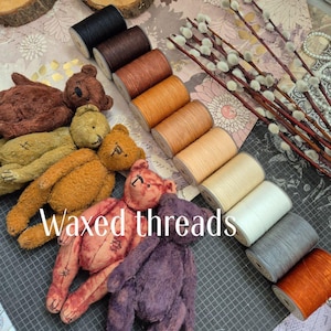 May include: An assortment of colorful waxed threads in various shades of brown, orange, and cream, alongside several handmade teddy bears. The image also includes pussy willow branches and the text "Waxed threads".