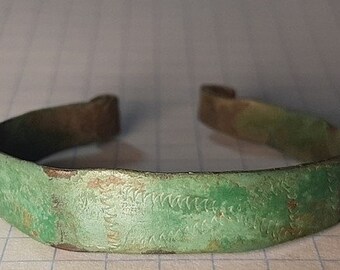 Plate bracelet with a pattern. Ancient Scythian bronze bracelet. Scythian bronze. Artifact of the 4th-6th century BC.