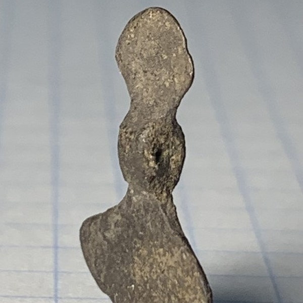 Double-sided axe amulet. Ancient amulet of a Viking warrior. Historical artifact.