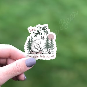 May include: A white sticker with a polar bear sitting in a forest with a bird and a rabbit. The sticker says "Yes, Jesus Loves Me. The Bible Tells Me So."
