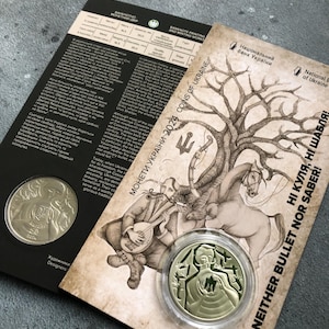 May include: A gold-colored coin with a design of a man holding a sword and a shield. The coin is in a clear plastic case. The background is a vintage-style illustration of a man playing a musical instrument with a horse and a tree. The text "NEITHER BULLET NOR SABER!" is printed on the background.