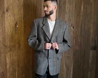 May include: A gray plaid blazer with a single button closure. The blazer has a notched lapel and two pockets on the front.