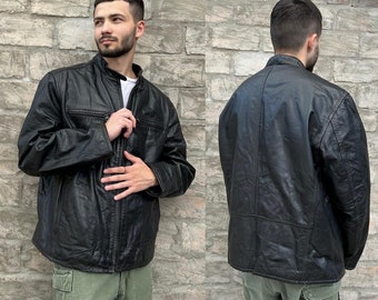 May include: A black leather jacket with a zipper closure and a stand-up collar. The jacket has a quilted lining and two pockets on the front.