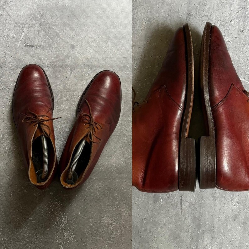 May include: A pair of brown leather ankle boots with laces. The boots have a pointed toe and a low heel.