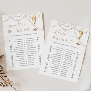 May include: Two white paper game cards with gold text and a champagne glass illustration. The cards read "Would She Rather" with a list of choices for a bridal shower game. Pearl and gold accents.