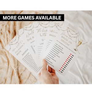 May include: A collection of white bridal shower game cards with gold text and decorative pearl accents. The games include "How Well Do You Know the Bride?" and "Guess Who Bride or Groom?" with a champagne glass illustration.