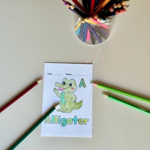 May include: A printable coloring page featuring an alligator with the letter A and the word "Alligator" below. The page has lines for the date and name.