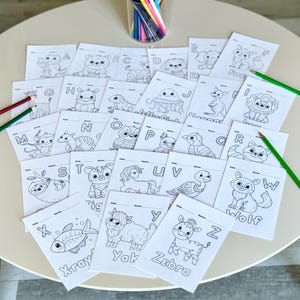 May include: Black and white coloring pages featuring animals and letters of the alphabet. Each page has a different animal and letter, such as a fox for F, a wolf for W, and a yak for Y.