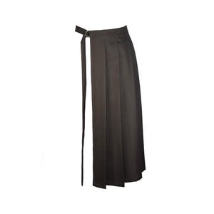 May include: A dark brown wrap skirt with vertical pinstripes. The skirt features a long, attached belt that threads through a silver-colored metal ring at the waist. The skirt has a midi length.