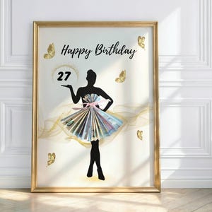 May include: A framed print with a gold border shows a woman's silhouette holding the number 27. The words "Happy Birthday" are written above. Gold butterflies and a flowing design are decorative elements.