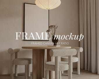 May include: A dining room scene featuring a round wooden table and three upholstered chairs. A framed canvas hangs on the wall. The text "FRAME mockup" is displayed above the table. A decorative light fixture hangs from the ceiling.