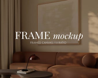 May include: A living room scene featuring a brown sectional sofa, a dark brown coffee table, and a modern lamp. A framed canvas with a neutral abstract design hangs on the wall. The text "FRAME mockup" and "FRAMED CANVAS / 1:1 RATIO" are visible.