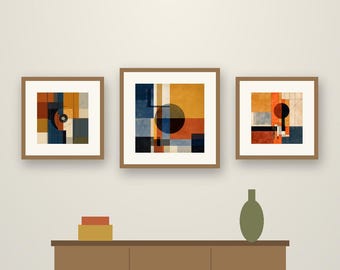 May include: Three framed square wall art prints featuring geometric compositions of circles and blocks in shades of orange, blue, and cream. The text reads Crestline Color Co. Circle & Block. Below, a brown sideboard holds two boxes and a vase.