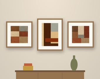 May include: A set of five framed wall art prints titled Earth Blocks by Crestline Color Co. The artwork features geometric blocks in shades of brown, red, blue, and cream. Below the art is a brown sideboard with a vase and two boxes.