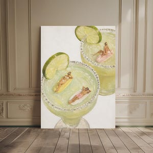May include: A painting of two large margarita glasses filled with pale green liquid and salt rims. Inside the glasses, tiny figures lounge on yellow, pink, and white pool floats. Each glass is garnished with a large, bright green lime slice.