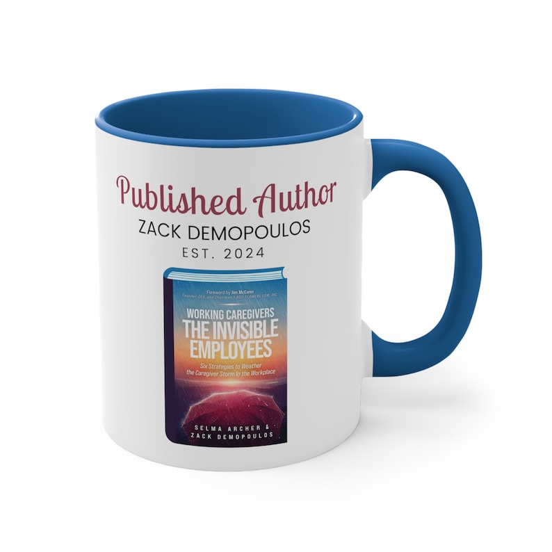 May include: White ceramic mug with a blue interior and handle. The mug features the text "Published Author ZACK DEMOPOULOS EST. 2024" in burgundy script. Below the text is a book cover image with the title "WORKING CAREGIVERS THE INVISIBLE EMPLOYEES".