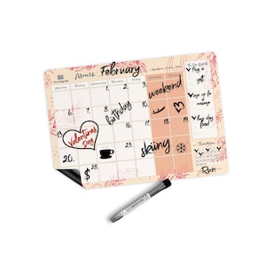 May include: A February-themed dry-erase calendar with a floral design. The calendar includes the days of the month, with the words "weekend", "birthday", "Valentines Day", and "skiing" written on certain dates. A black dry-erase marker is included.