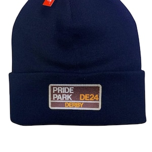 Derby Pride Park beanie hat. Embroidered in team colours white and yellow. Perfect present for football fan. Football ground inspired.