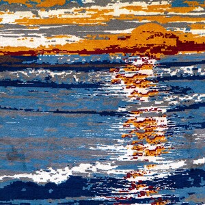 May include: Abstract rug with a sunset design. The rug features a blend of blue, gray, orange, and red hues, creating a textured, artistic appearance. The design evokes a seascape with a setting sun, suitable for home decor.