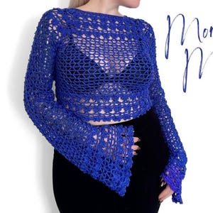 Peut inclure: Un haut crocheté bleu royal avec de longues manches bouffantes. Le haut est réalisé avec un motif de point ouvert délicat.