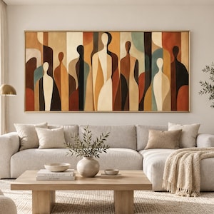 May include: A large rectangular wall art piece featuring an abstract composition of elongated, stylised human-like figures in a palette of warm earth tones, including shades of brown, cream, terracotta, and muted teal, framed in a thin gold border.