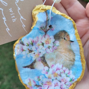 Sweet baby bird and blossom anytime oyster shell ornament with two pearls. Sweet gift.