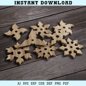 May include: A set of six wooden cutouts in the shape of snowflakes and ninja stars. The cutouts are arranged on a wooden surface.