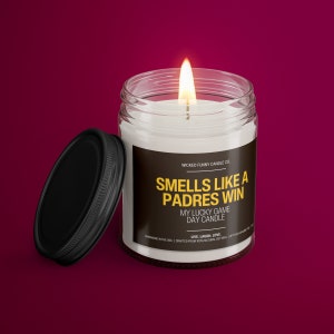 a candle with a lid on a red background