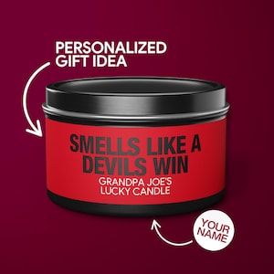 May include: A black and red candle tin with the text "Smells Like A Devils Win" and "Grandpa Joe's Lucky Candle".