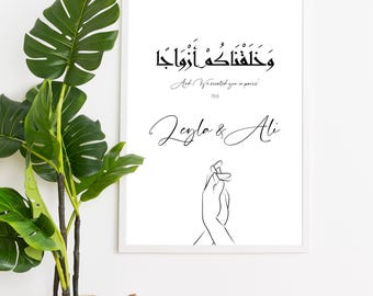 May include: Black and white printable art print with Arabic calligraphy that reads "We created you in pairs". The print also includes the names "Leyla & Ali" in cursive script and a line drawing of two hands holding each other.