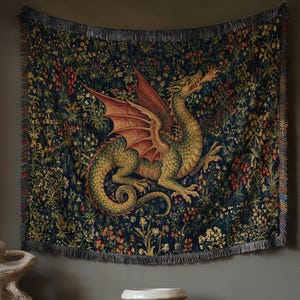 May include: A rectangular woven wall tapestry featuring a large green and red dragon breathing fire, set against a dark blue background filled with intricate floral and botanical patterns, finished with a fringed edge along the bottom border.