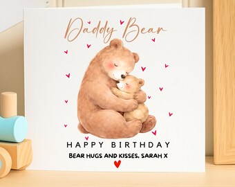 May include: A white greeting card with a watercolor illustration of two hugging bears. The text "Daddy Bear" is written in a cursive font above the bears. Below the bears, the card reads "Happy Birthday Bear Hugs and Kisses, Sarah X".